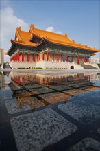 Taipei National Concert Hall beautifully reflected in a puddle of rainwater