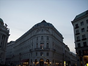 Evening street scene with illuminated facades and charming café on the corner, Vienna, Austria,