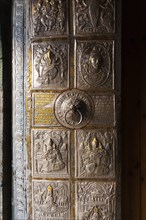 The ornamental metal door entrance to Bhimakali Temple covered in inscriptions and reliefs in