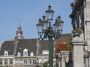 Streetlights and buildings in a historic city with ornate architecture and flowers, maastricht.