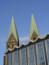 Church with two green towers and a modern building in the foreground, Bremen, Germany, Europe