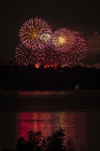 Fireworks over a lake with a reflection in the water