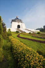 Colorful flowers and grass at the base of the Chiang Kai Shek Memorial Hall in Taipei. Vertical