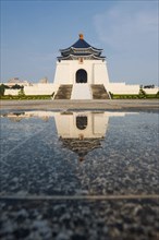 The Chiang Kai Shek Memorial Hall reflected in a puddle of rainwater