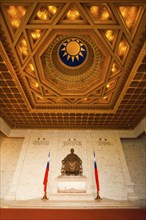 A beautifully ornate ceiling and a statue of Chiang Kai Shek inside the cavernous Memorial Hall in