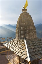 A minor temple at Bhimakali Temple complex overlooks the view of the Himalayas in Sarahan, Himachal