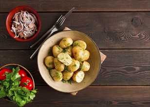 Fresh Cooked, new potatoes, with dill, on a wooden table, selective focus. close-up, toning, no