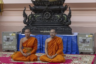 Monks in front of a Buddha statue, Bhumispara-mudra, Buddha Gautama at the moment of enlightenment,