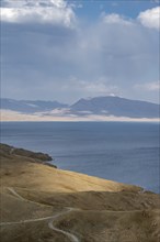 View of mountain landscape with piste at Lake Song Kul, Naryn region, Kyrgyzstan, Asia