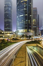 Traffic with streets and skyscrapers in the city of Hong Kong at night in Hong Kong, China, Asia