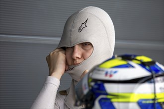 10 May 2024, Hockenheimring Germany : Spanish racing driver Alba Vazquez puts on her balavlava and