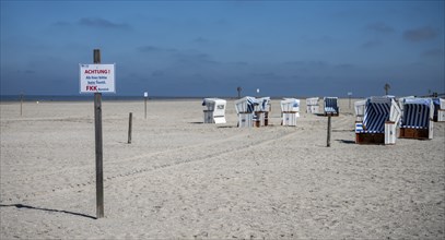 Beach chairs and signs on the sandy beach of the North Sea, Sankt Peter-Ording, Schleswig-Holstein,