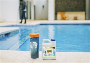 Clarifier for cleaning swimming pools. Clarifying chemical at the edge of a swimming pool