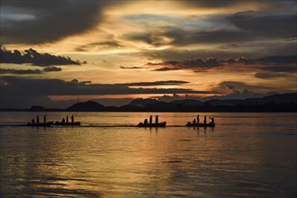 Boats of State Disaster Response Force (SDRF) personnel passing by Brahmaputra River during a