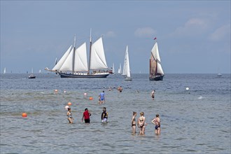 Sailing ships, sailing boats, people standing in the water, Kieler Woche, Kiel Fjord, Kiel,