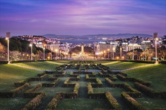 View of Lisbon Marquis of Pombal Square seen from the Eduardo VII Park in the evening twilight.