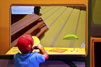 Child in front of a screen with a computer game, Gamescom trade fair, the world's largest trade