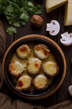 Traditional Georgian dish, appetizer, stuffed mushrooms, Sulguni cheese, baked in a Ketzi clay pan,