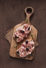 Breakfast, bacon and olives sandwich, on a cutting board, top view, close-up, no people