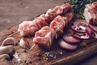 Raw pork meat, on wooden sticks, pickled kebab, with spices, top view, no people