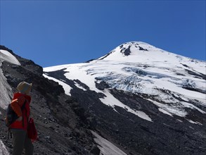 Woman at the snow-covered Osorno volcano, Chile, South America