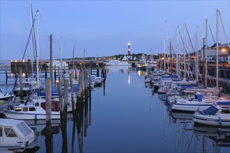 Harbor with sailing boats and lighthouse at dusk, Sylt, North Frisian Islands, Hörnum, North Sea,