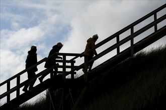 People walking up a staircase, backlight, silhouette