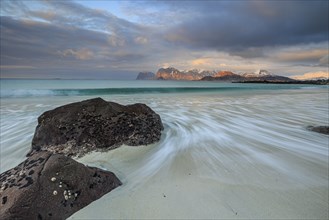 Rocks and beach in front of Bergen, sea, surf, spray, clouds, winter, Flakstadoya, Lofoten, Norway,