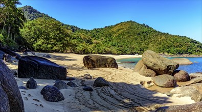 Forest, hill, rocks and sea of stunning Indaiauba beach in Ilhabela island coast os Sao Paulo,