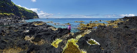 A rocky coastal landscape with cliffs and the sea under a clear blue sky, Natural thermal water