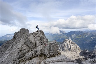 Mountaineer on a narrow rocky ridge, Watzmann crossing to Watzmann Mittelspitze, view of mountain