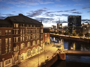 Aerial view of Hamburg's Speicherstadt warehouse district on the Zollkanal during the blue hour,