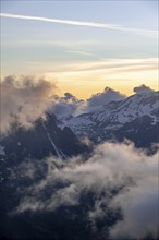 Mountain landscape at sunset, clouds around mountain peaks, Chamonix, Haute-Savoie, France, Europe