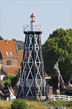 Small lighthouse at the entrance to the city harbour in Enkhuizen, North Holland, West Friesland,