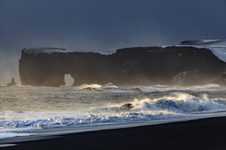 Snowy beach, waves, wind, dark clouds, winter, light mood, rocks, Dyrholaey, Vik, Iceland, Europe