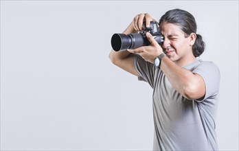 Male photographer taking photos isolated. Handsome photographer taking photos with dslr camera