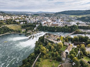 Aerial view of the Rhine Falls with Laufen Castle with autumnal vegetation, on the horizon the town