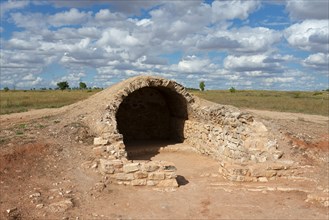 A stone vault in an archaeological site under a cloudy sky, Cueva, cave, Cerro de los molinos, mill