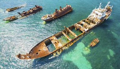 Abandoned, rusty shipwrecks in blue seawater showing destruction and decay, symbol photo, AI