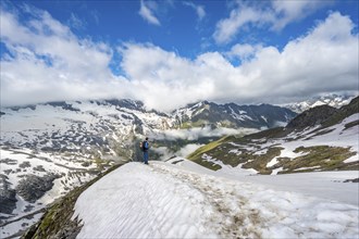 Mountaineer on hiking trail with snow, mountain landscape with summit Hoher Weißzint and