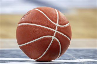 Close-up of basketball on the floor of a hall