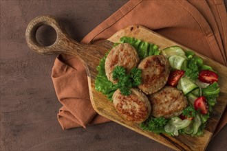 Fried cutlets, turkey, with vegetable salad, top view, no people