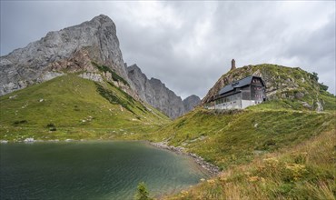 Wolayersee and Alpine Club hut Wolayerseehütte, rocky cloudy mountains, Carnic Alps, Carnic High