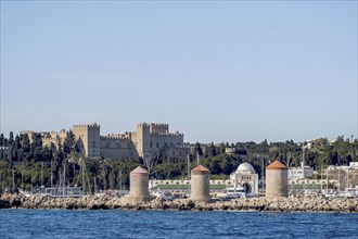 Exit from the harbour, view of the Grand Master's Palace and the three windmills, Rhodes,