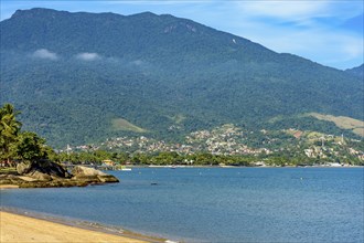 Seafront of the city of Ilhabela with its beaches, mountains and forests on a sunny day, Ilhabela,