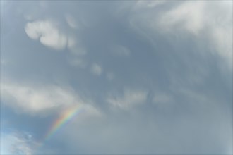 Rainbow appears in rain clouds in spring. Bas Rhin, Alsace, France, Europe