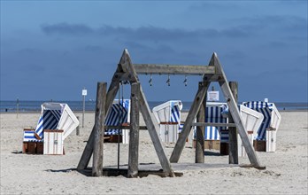 Beach chairs and signs on the sandy beach of the North Sea, Sankt Peter-Ording, Schleswig-Holstein,