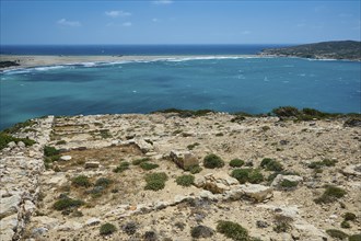 Ruins on a hill overlooking a wide coastline and turquoise waters, archaeological site, Vroulia,