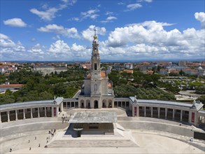 Central focus on a basilica with square and stairs, sky with white clouds, aerial view, Basilica of