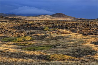 Large lava field and volcanic crater in the midnight sun, clouds, mood, Burfellshraun, Myvatn,